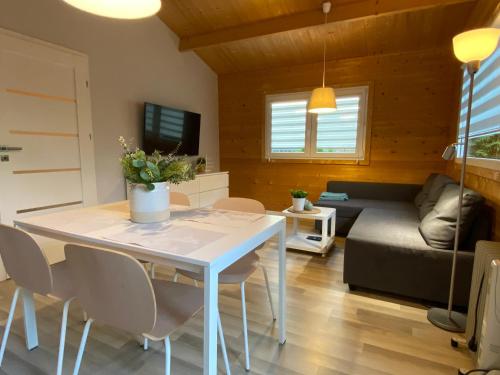 a living room with a table and chairs and a couch at Przystanek Ińsko in Ińsko