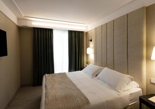 a hotel room with a bed and a window at Ceccarini 9 home suite home in Riccione