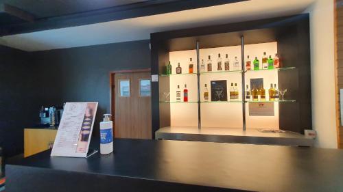 a counter with a display of bottles of alcohol at ibis Manaus Distrito Industrial in Manaus