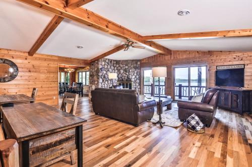 a living room with a couch and a tv at Whispering Pines Point in Boulder Junction