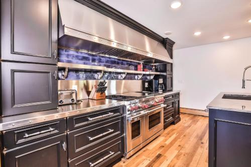 a large kitchen with stainless steel appliances and wood floors at Whispering Pines Point in Boulder Junction