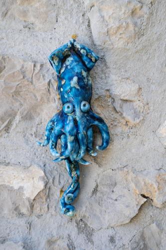 a blue object sitting on top of some rocks at Villa Denise in Vico Equense