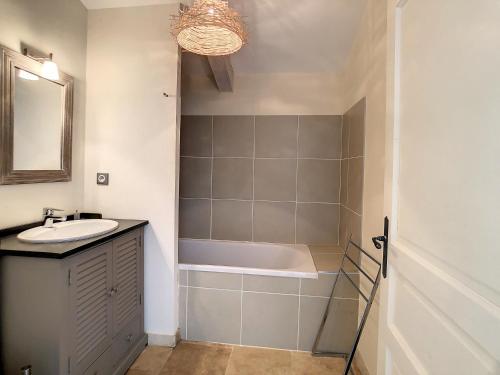 a bathroom with a sink and a bath tub at **LOVELY APARTMENT IN THE CASTLE OF LA REDORTE** in La Redorte