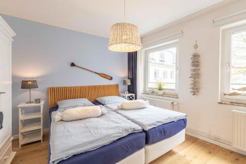 a bedroom with a bed with two pillows on it at Captains Lounge in Eckernförde