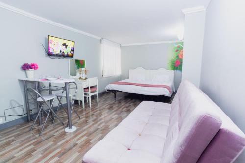a living room with a couch and a table at ApartaSuites & Hotel Bogota Suamox in Bogotá