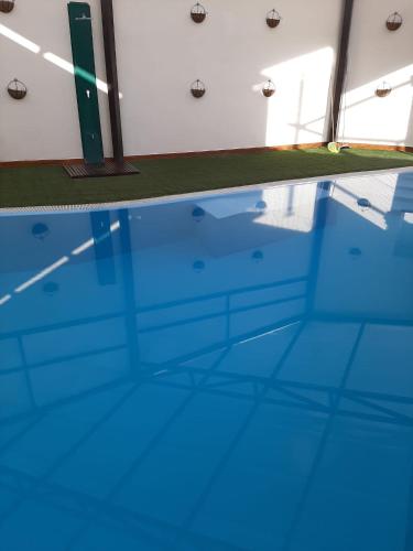 an empty swimming pool with blue water at Casa Rural La Sureña in Ossa de Montiel