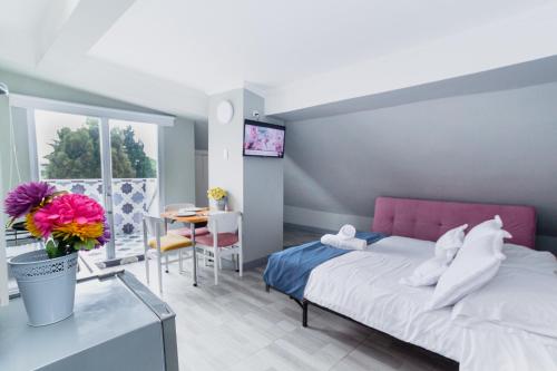 a small bedroom with a bed and a table and a tableablish at ApartaSuites & Hotel Bogota Suamox in Bogotá
