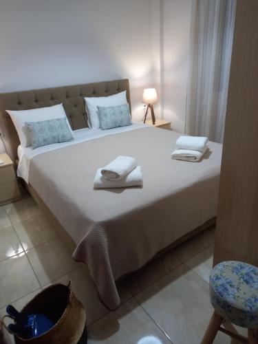 a bedroom with a large bed with towels on it at Elena House in Kalamaki