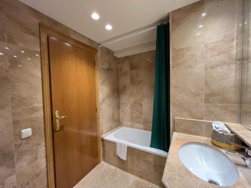 a bathroom with a sink and a bath tub at Apartamento Vela 1 Cambrils Playa in Cambrils