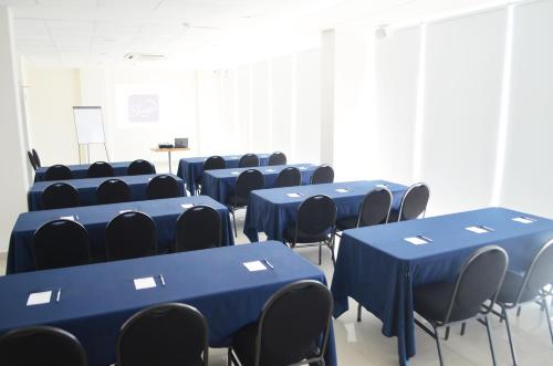 a room with blue tables and chairs in it at Sleep Inn Mazatlan in Mazatlán