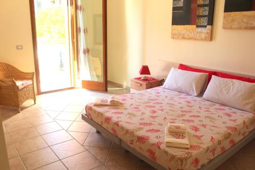 a bedroom with a large bed with a red head board at Sunway Apartments 2 in Alghero