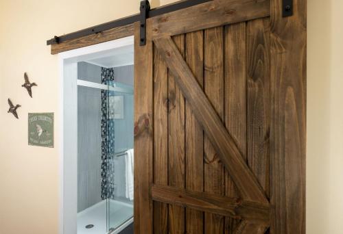 a sliding barn door in a room with a mirror at Magnolia Manor and Chapel in Humboldt