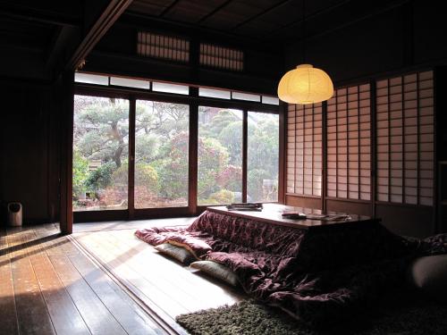 
a living room filled with furniture and a window at Guesthouse Nara Backpackers in Nara
