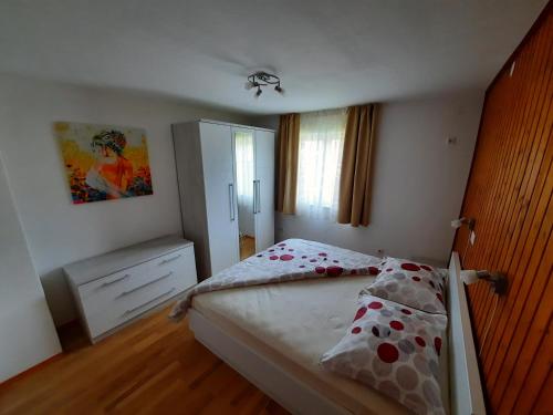 a bedroom with a bed with polka dot sheets at Apartmani Scripea in Škrip