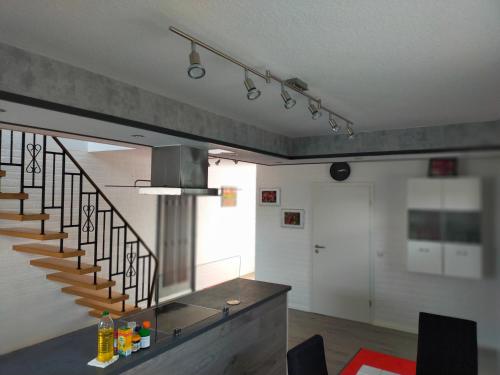 a living room with a staircase and a hallway at Exklusive FeWo Papenburg mit Terrasse & beheiztem Wintergarten in Papenburg