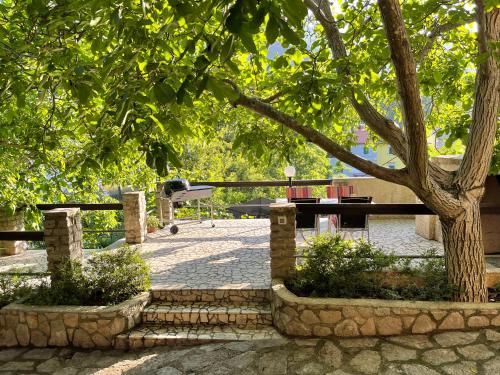 a park with a picnic table and a tree at Apartments Šmit in Cres