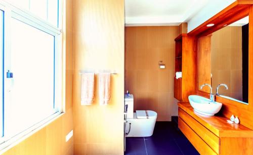 a bathroom with a sink and a toilet at Oak Residencies in Kiribathgoda