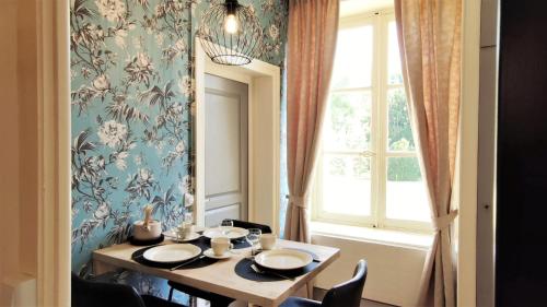 a dining room with a table and a window at Château La Mothaye in Brion