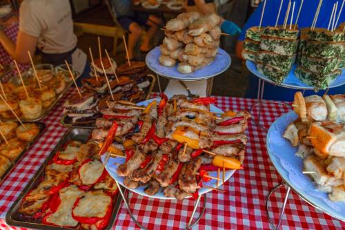 a table with plates of food on a red checked table cloth at La casa di Dante in Palermo