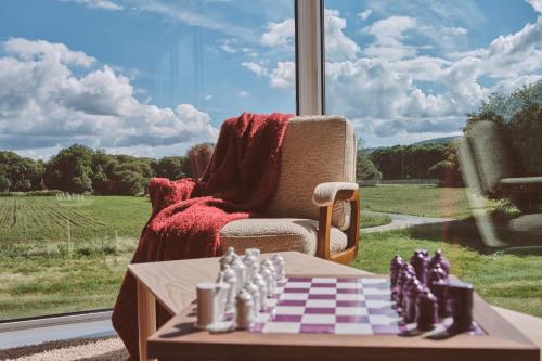 a chess board on a table in front of a window at Casa Jacoba Pool House by Serendipia Turismo in Ortoño