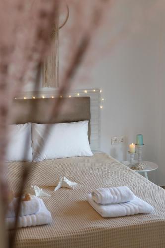 a bedroom with a bed with two towels on it at Anatoli Apartments Polichrono in Polychrono