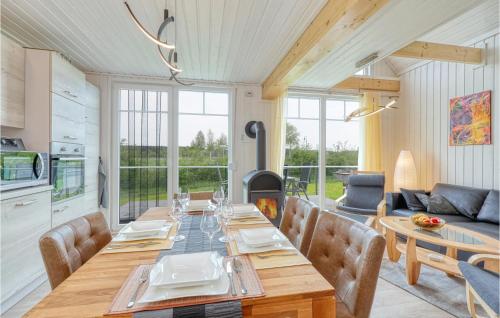 a dining room with a table and a fireplace at 2 Bedroom Nice Home In Zerpenschleuse in Zerpenschleuse