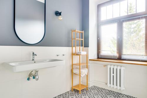 a bathroom with a sink and a mirror at Pensjonat Lider in Szklarska Poręba