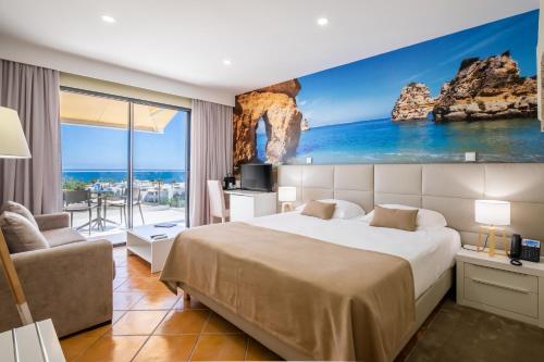 a hotel room with a bed and a view of the ocean at Lagos Atlantic Hotel in Lagos