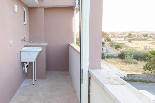 a bathroom with a sink and a window with a view at serendipity la terrazza house in Lecce