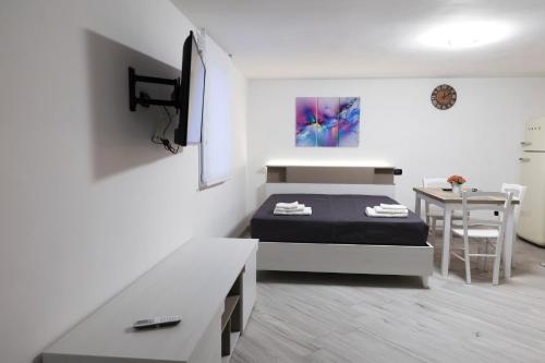 a small bedroom with a bed and a table at serendipity la terrazza house in Lecce