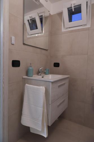 a bathroom with a sink and a mirror at serendipity la terrazza house in Lecce