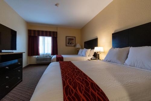 a hotel room with two beds and a television at Comfort Inn Near Grand Canyon in Williams
