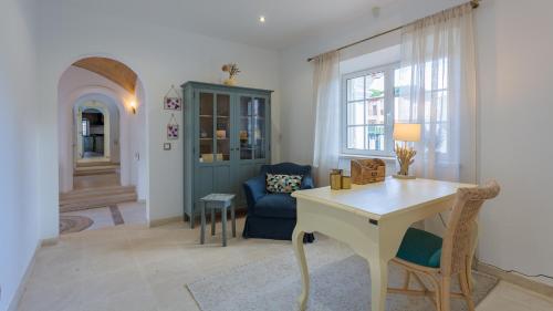 a living room with a desk and a blue chair at Portuguese mansion close to marina, golf and beach. in Vilamoura