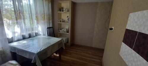 a small room with a table and a window at Одна комнатная квартира в центре in Shymkent