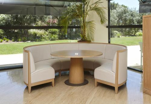 a table and two chairs and a table with a plant at Crowne Plaza Vilamoura - Algarve by IHG in Vilamoura