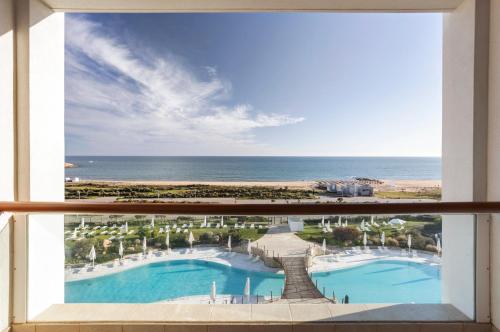 a view of the ocean from the balcony of a resort at Crowne Plaza Vilamoura - Algarve by IHG in Vilamoura