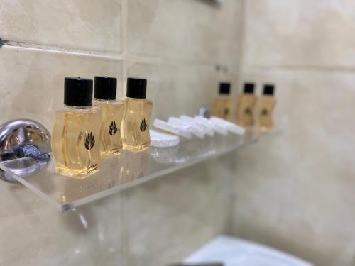 a row of bottles on a shelf in a bathroom at Reydel Hotel in Istanbul