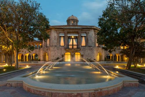 a building with a fountain in front of it at Quinta Real Aguascalientes in Aguascalientes