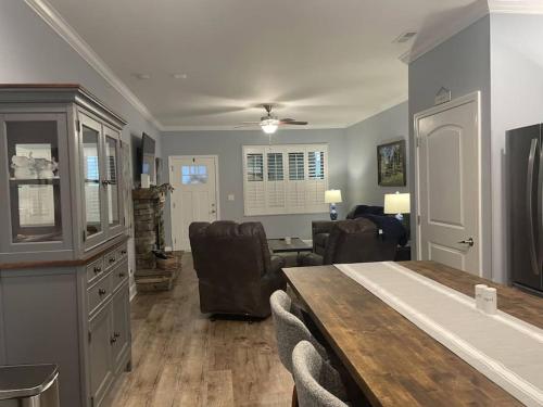 a living room with a dining table and a living room at Cades Cove Paradise SoftTub Spa Fireplace in Townsend
