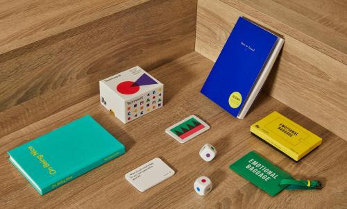 a table with a book and a box and dice at Crowne Plaza Hamburg-City Alster by IHG in Hamburg