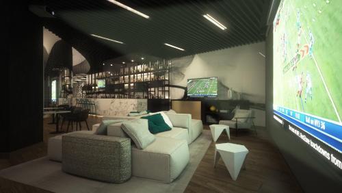a living room with a couch and a large screen at Live Aqua Cancun - Adults Only - All-Inclusive in Cancún