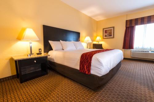 a hotel room with a large bed and two lamps at Comfort Inn Near Grand Canyon in Williams