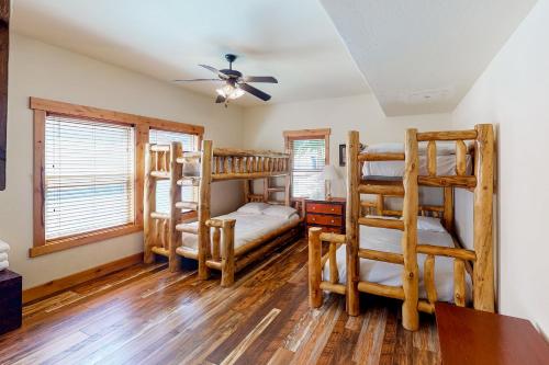 a bedroom with four bunk beds and a desk at Iyer Lakehouse in Bass Lake