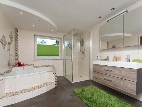 a bathroom with a tub and a sink and a shower at MyHome Apartments Ambach in Oetz