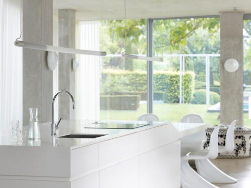 a white kitchen with a sink and a large window at H-House Architectural Residence in Maastricht