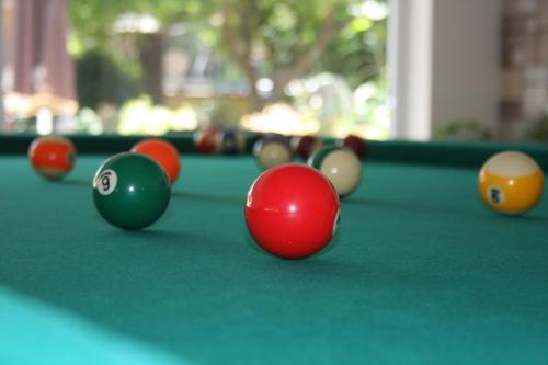 a group of billiard balls on a pool table at Palmea Hotel in Marmaris
