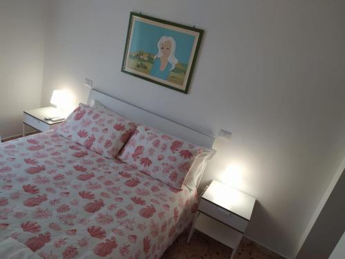 a bedroom with a bed and a picture on the wall at Apartments for you in Matera