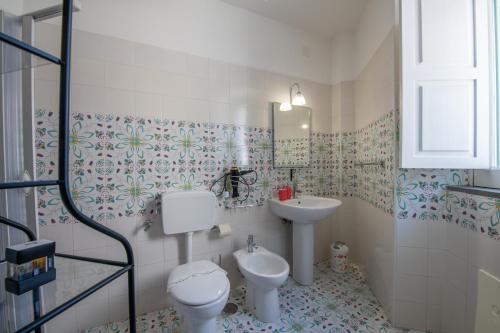 a bathroom with a toilet and a sink at Villa Lery - Azzurra Home in Agropoli
