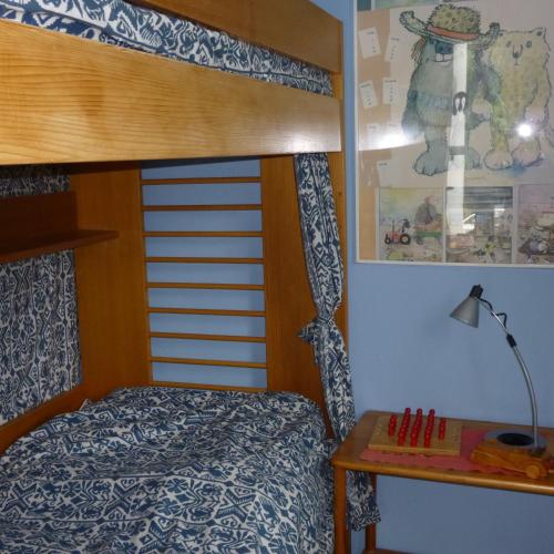 a bedroom with a bunk bed and a table at Bella Boltenhagen in Boltenhagen
