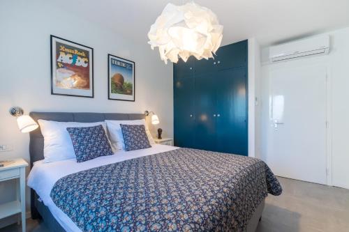 a bedroom with a large bed and a chandelier at Villa Pinus in Stari Grad